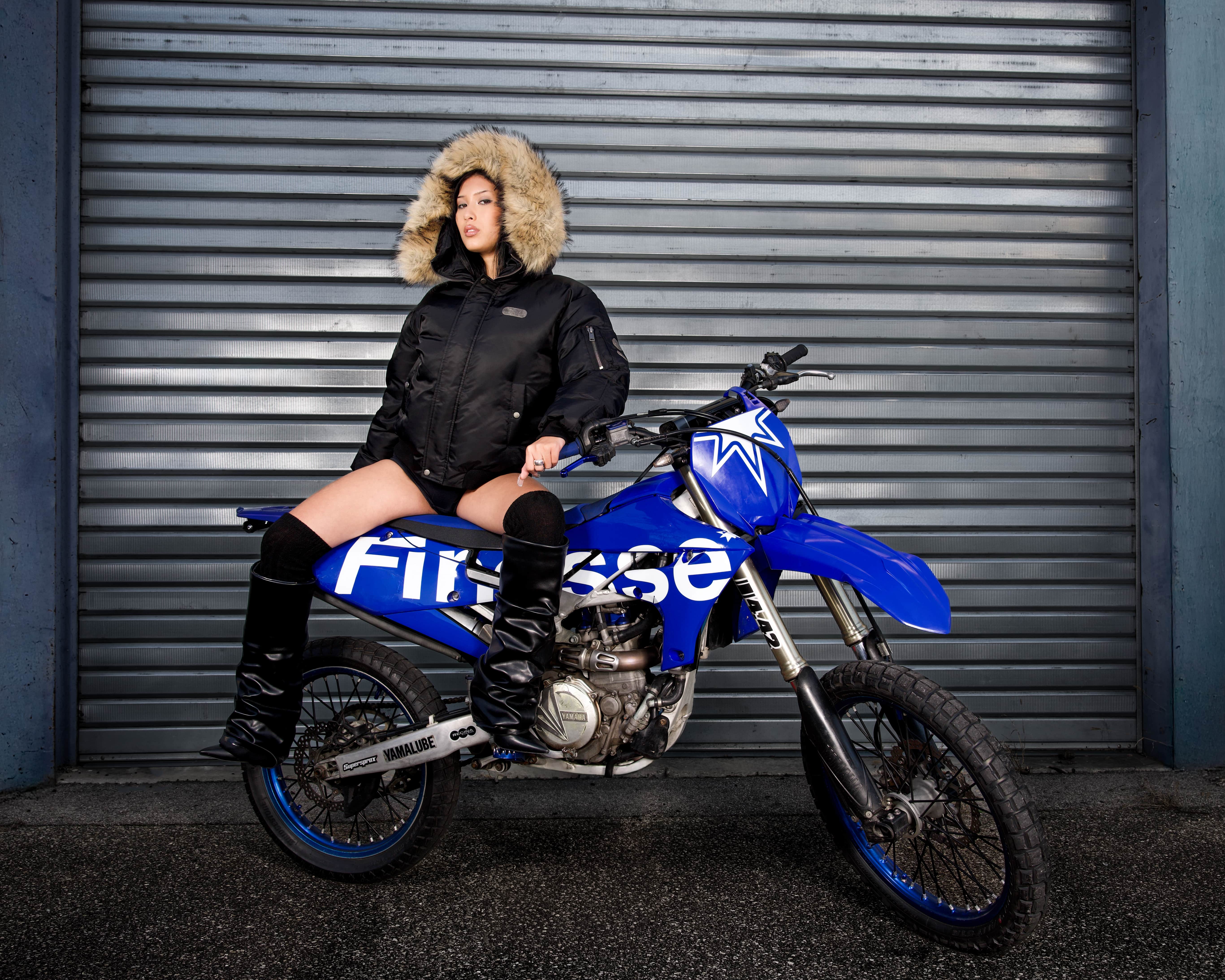 Deux mannequins portant les doudounes Finesse* Alive Puffer Jacket Ice Blue et Light Bronze devant un mur bleu.