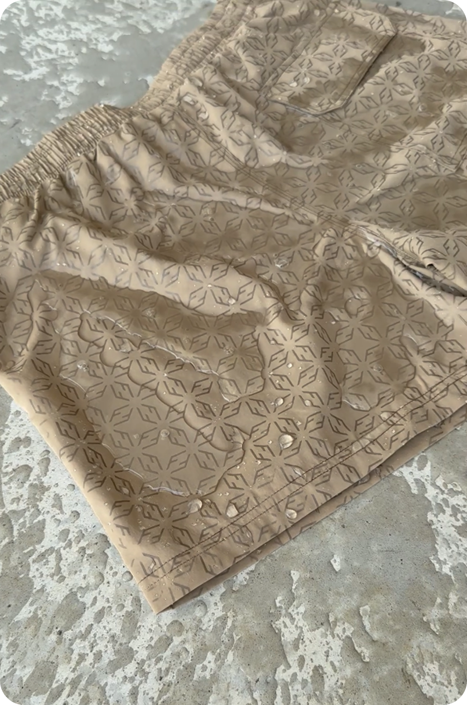 Swim Shorts Big Brown mouillé au sol révélant son monogramme unique